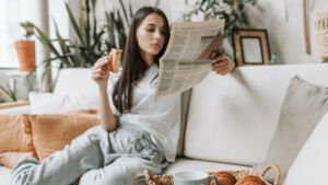 Vrouw leest de krant bij het ontbijt